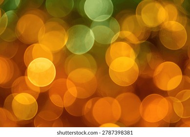 A soft focus background featuring numerous out-of-focus circular lights in warm shades of orange, yellow, and green, creating a dreamy and festive atmosphere.