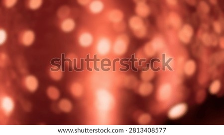 A soft focus background filled with glowing bokeh lights in warm orange and red hues, creating a festive and magical atmosphere.