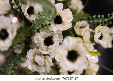 Soft focus background of white flowes with green stilks and blades.