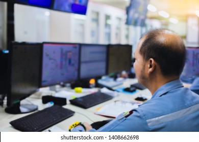 Soft Focus Of Bald Man Engineer Works With The Tablet In The Production Control Room Of A Steam Turbine,Generators Of The Coal-fired Power Plant For Monitor Process, Business And Industry Concept