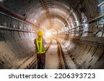 Soft focus and blurred lighting background of focus at engineer or technician control. Underground tunnel infrastructure. Transport pipeline by Tunnel Boring Machine for electric train subway