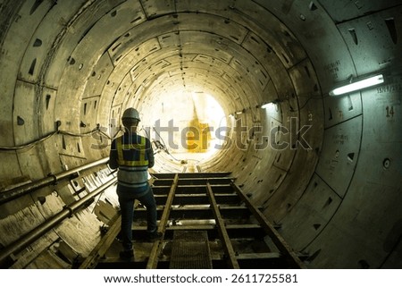 Soft focus and blurred lighting background of focus at engineer or technician control. Underground tunnel infrastructure. Transport pipeline by Tunnel Boring Machine for electric train subway. 
