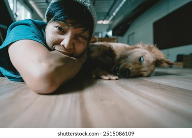 Soft focus blurs the face of the person, Selective focus A real Asian man takes a selfie golden retriever. The dog is playing together Looking funny at the camera at home. - Powered by Shutterstock