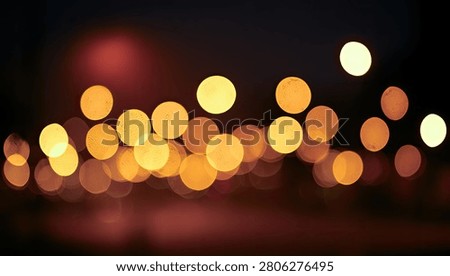 Soft focus bokeh lights in warm golden and orange hues create a dreamy, abstract background perfect for festive or atmospheric themes.
