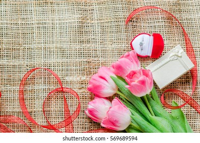 Soft Focus Bouquet Of Pink Tulips With Water Drop On Petal With Gift Box And Dimond Rig For Background.