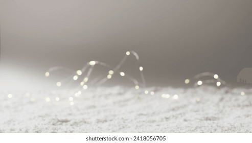 A soft focus captures twinkling fairy lights on a surface. The blurred lights create a dreamy, festive atmosphere, often used in home decor. - Powered by Shutterstock