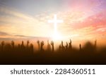 soft focus of Christian worship with raised hand on white cross background