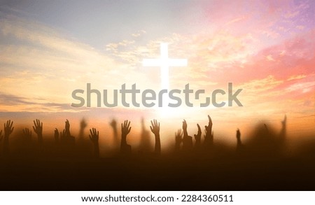 soft focus of Christian worship with raised hand on white cross background