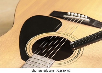 Soft Focus Of Condenser Microphone With Acoustic Guitar In Vintage Tone. Music And Sound Record Concept.