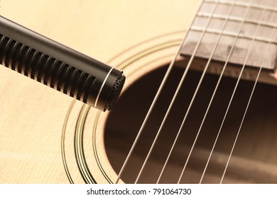 Soft Focus Of Condenser Microphone With Blurred Acoustic Guitar In Vintage Tone. Music And Sound Record Concept