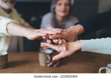 Soft Focus Of Crop Anonymous Elderly Friends Gathering At Table Joining Hands In Circle While Celebrating Special Event Support And Unity Concept