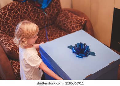 Soft Focus Cute Caucasian  Blonde Five Years Boy Child Opening Birthday Gift Present Box In His Room Home. Lifestyle. Birthday Party For Kids.