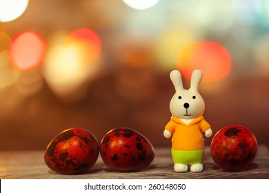 soft focus of easter decorate with rabbit toy and easter eggs on night light bokeh background. vintage color tone.