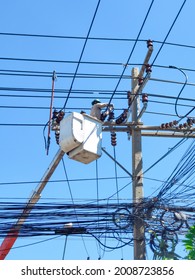 Soft Of Focus. Electrical Engineers Working On Electricity Pylon High Tension Power Line Repairs And Maintenance.