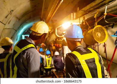 soft focus of Engineers wear helmet,vests safety .Technician control underground tunnel construction at working shaft to maintenance.Transport pipeline by Tunnel Boring Machine(TBM) method for train.