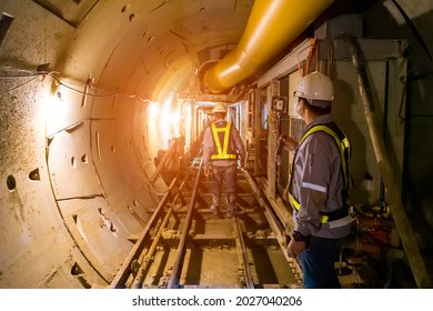 Soft Focus Of Engineers Wear Helmet,vests Safety .Technician Control Underground Tunnel Construction At Working Shaft To Maintenance.Transport Pipeline By Tunnel Boring Machine(TBM) Method For Train.