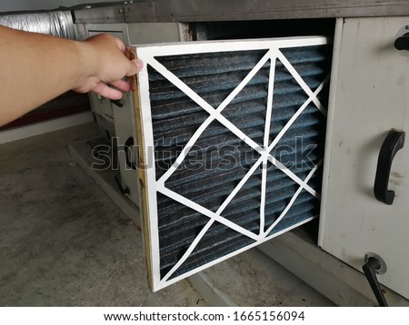 Soft Focus to Filter of Air handing Unit, Technician checking a Pre-filter of air handling unit for replacement a new filter - HVAC maintenance