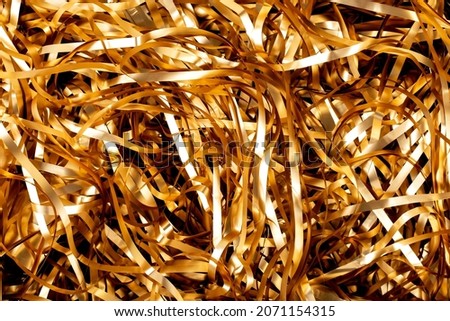 Soft focus, golden spirals tinsel. serpentine, background, blur. holiday new year 2022. 