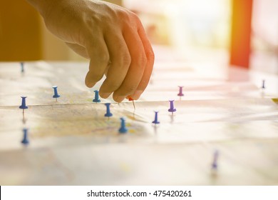 Soft Focus Hand Holding Paper Pin On Blur Perspective Road Map,copy Space.filter Color Effect.