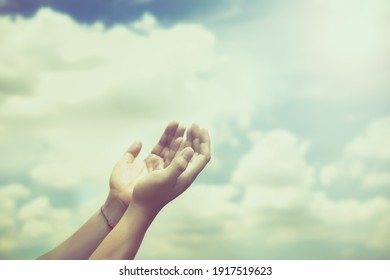 Soft focus of hands of human are pray and worship on blue sky background with sunlight, Soul of prayer man, Spirituality with believe and religion
