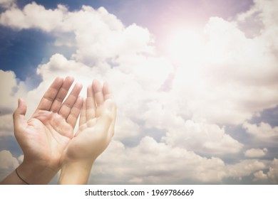 Soft focus of hands of human are pray and worship on blue sky background with sunlight, Soul of prayer man, Spirituality with believe and religion 
