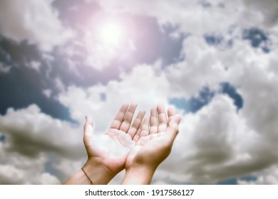Soft focus of hands of human praying on blue sky background with sunlight,Spirituality with believe and religion