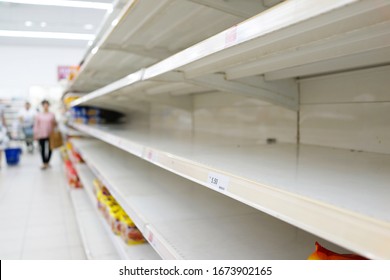 Soft Focus Image Of Empty Shelves In A Grocery Store. People Panic Buying Sparked By The Virus Outbreak.           