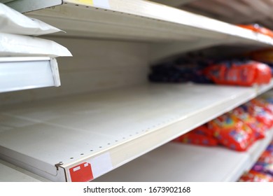 Soft Focus Image Of Empty Shelves In A Grocery Store. People Panic Buying Sparked By The Virus Outbreak.           