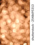 A soft focus image features a multitude of out-of-focus circular lights in warm, amber tones. The effect creates a dreamlike, hazy quality reminiscent of a golden sunset reflected on water.