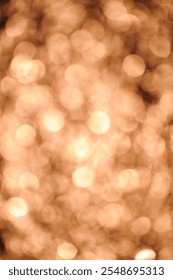 A soft focus image features a multitude of out-of-focus circular lights in warm, amber tones. The effect creates a dreamlike, hazy quality reminiscent of a golden sunset reflected on water.