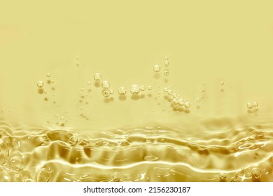 Soft focus lite yellow cosmetic moisturizer floral water, micellar toner, or emulsion abstract background. Reflections of  scattered sun texture.