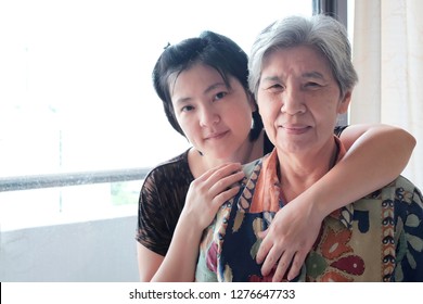 Soft Focus At Lovely Asian Family. Pretty Daughter 40 Years Old Hug And Taking Care Her Mother 76 Years Old. Concept Happiness Family, Love Support And Take Care Elderly. Mother Day , Elderly Day.   