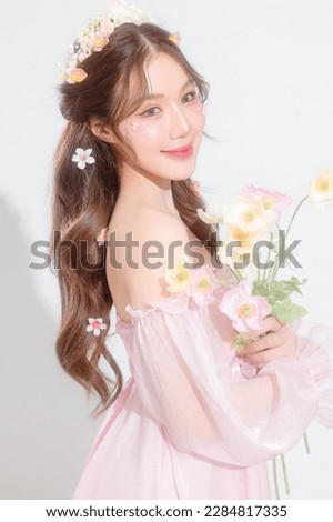 Soft focus. Lovely Asian woman have perfect clear fresh skin with flower make up on her face over isolated white background. Cosmetology, beauty and spa, wellness, Plastic surgery.