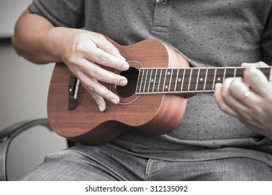 Soft Focus Of Man Playing Ukelele