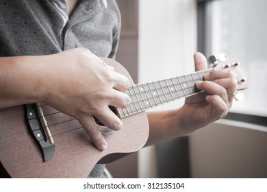 Soft Focus Of Man Playing Ukelele