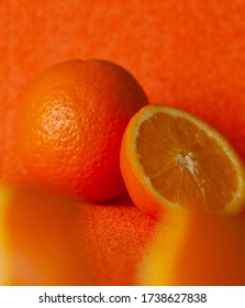 Soft Focus Of Monochromatic Food Composition With Whole And Cut Organic Tropical Fruit On Orange Background