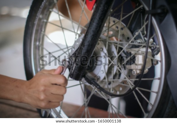 Soft Focus , Motorcycle repair\
workers are using the tire removal tool inside to repair\
patches
