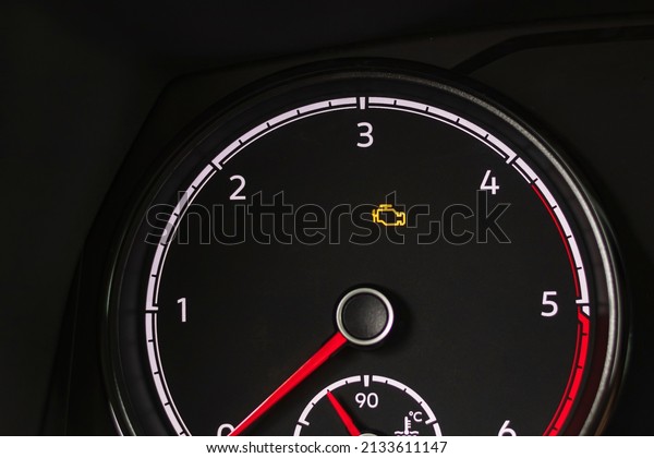 soft focus.\
natural light. the dashboard. the indicator is lit, the engine\
error is a check. there is a\
tinting