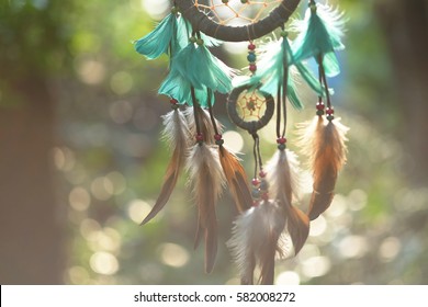 Soft focus on Dream Catcher Blue Coral with natural background in vintage style. Native american dream catcher. boho chic, ethnic amulet.