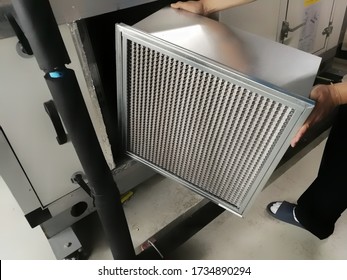 Soft Focus on Man hold a Filter of Air handing Unit, Technician checking a Medium -filter of air handling unit for replacement a new filter - HVAC maintenance