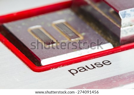 soft focus pause button, focusing on the word pause, retro concept