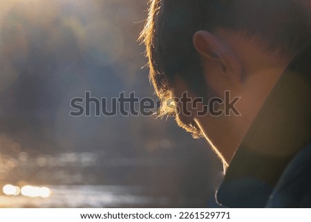 Soft focus photo. Person face  lit with sunset sunlight. Autumn park walk.