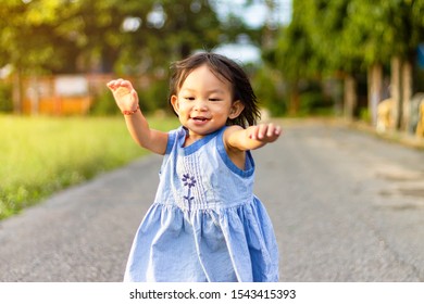 Soft Focus. Portrait Image Of 1-2 Years Old Baby. Happy Asian Child Girl Smiling And Running On The Road At The Park.