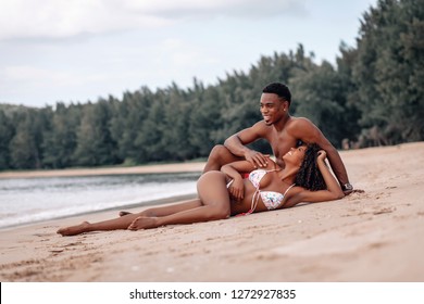 Soft focus portrait of a loving African American couple lying near the sea. Phuket. Thailand. Trip to warm destination