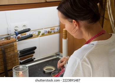 Soft Focus Rear View, Woman Cooking In The Kitchen. Housewife Prepares The Food