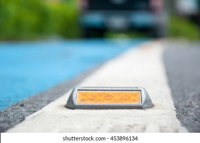 Soft Focus Of Reflector Or Stud On Asphalt Road