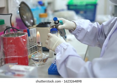 Soft Focus Scientist Is Holding Auto Pipette And Open Lid Of Tube By Aseptic Technique