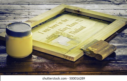 Soft Focus Screen Printing Squeegee On Silk Screen Frame And Yellow Ink