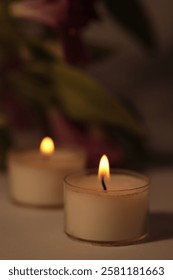 Soft focus. smoke blur Burning Candles in dark. Evening, night Light and shadow beige background. Minimalist still life.
