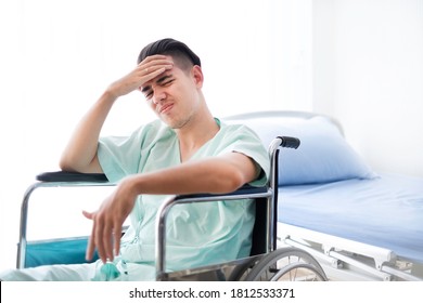 Soft Focus. Stressed Male Patient Sitting In Hospital With Hand Cover Hand As Cannot Afford Medical Expense. The Stressed Male Patient Has No Money & Health Insurance. Worrying Sick Patient Concept.